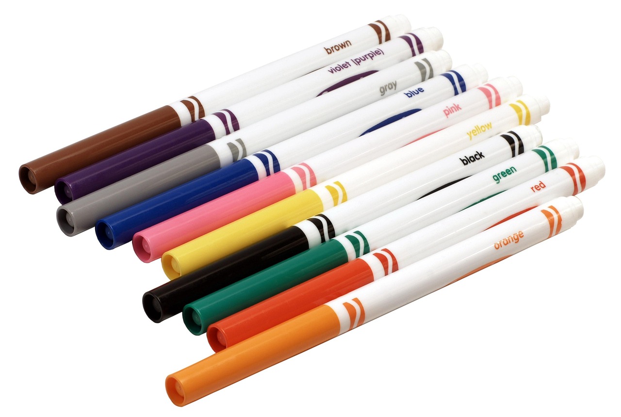 A set of dual tip brush markers laid out