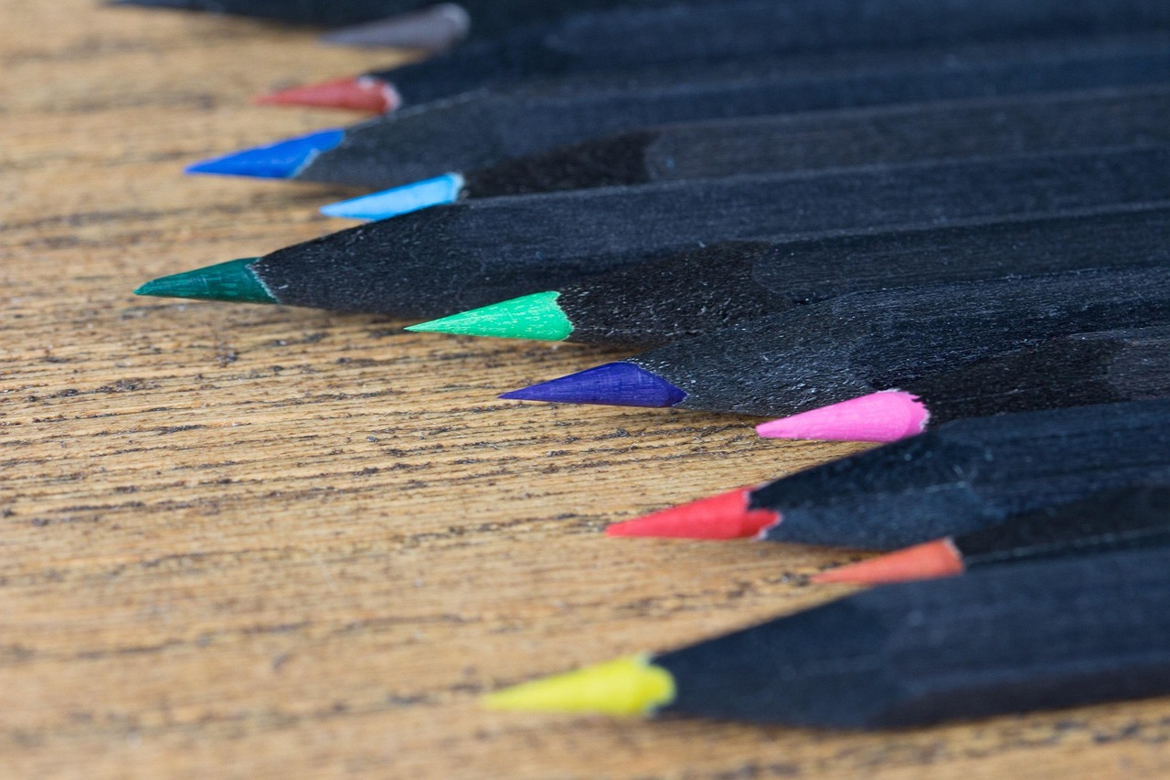 A row of coloured pencils in assorted colours