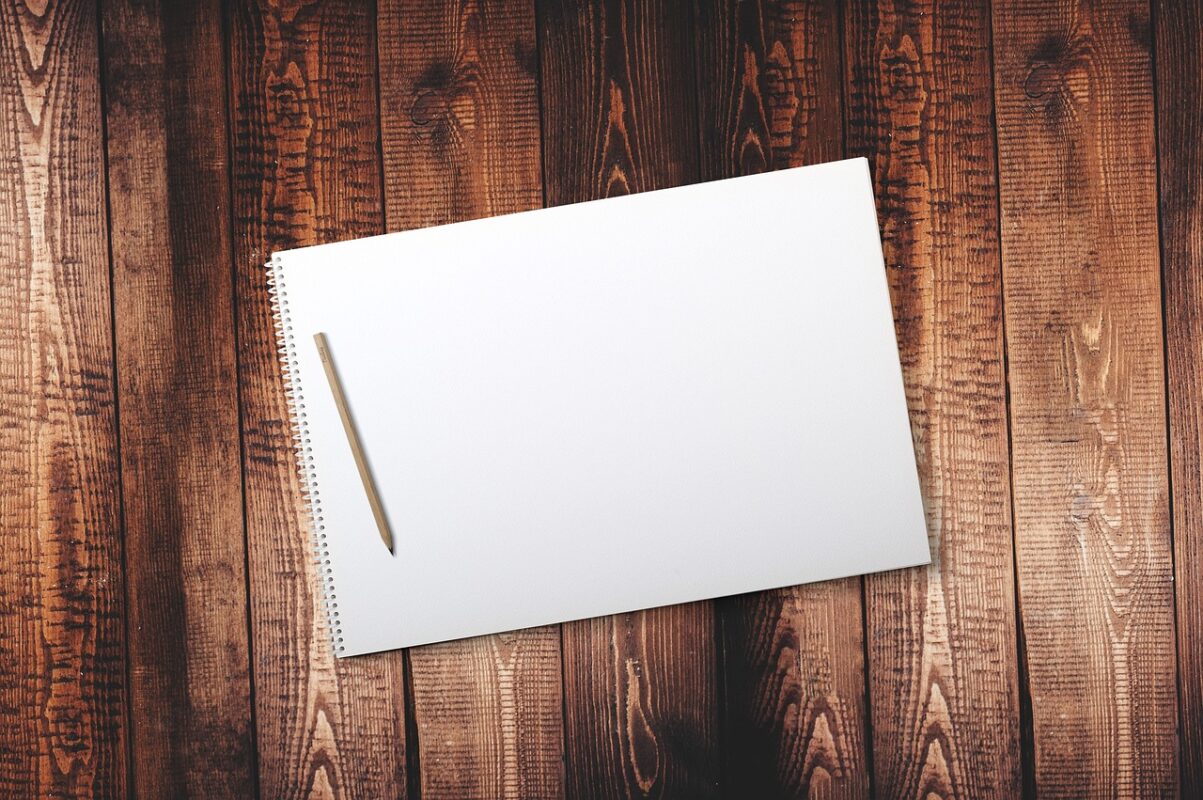 A blank sketchbook open on a table