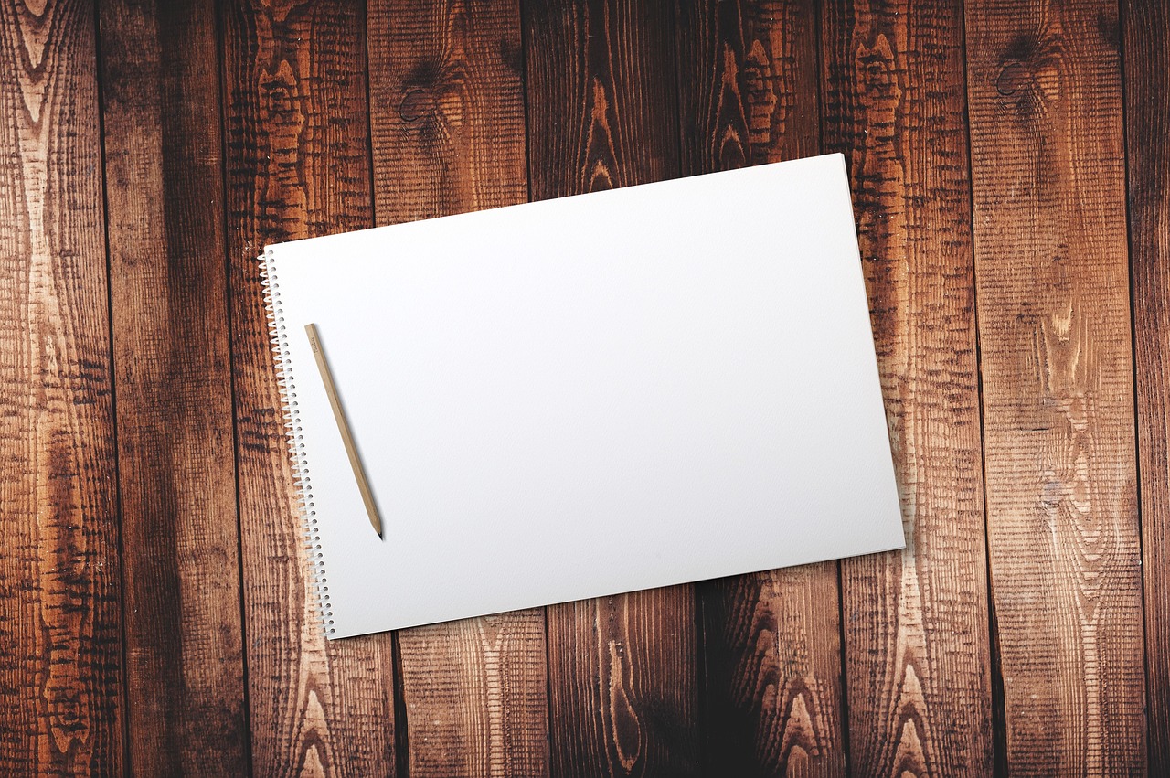 A blank sketchbook open on a table